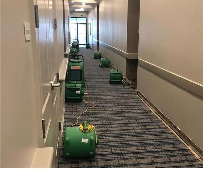 air movers in flooded hallway of hotel