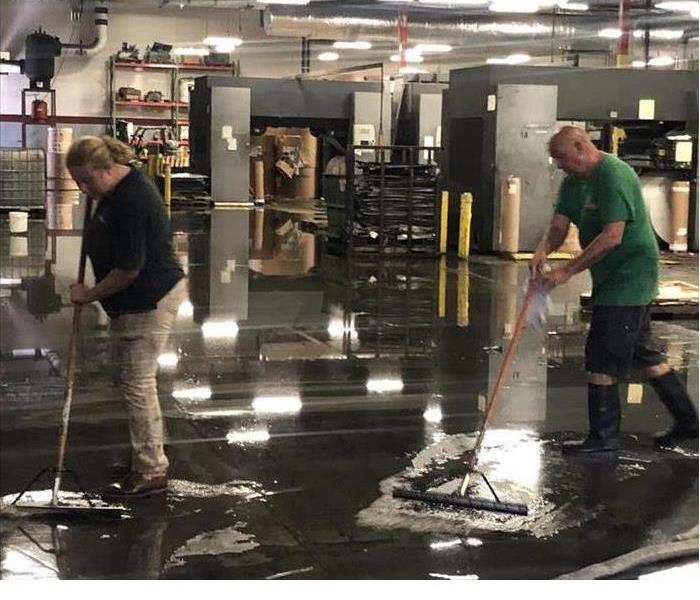 techs cleaning water from flooded Jacksonville warehouse